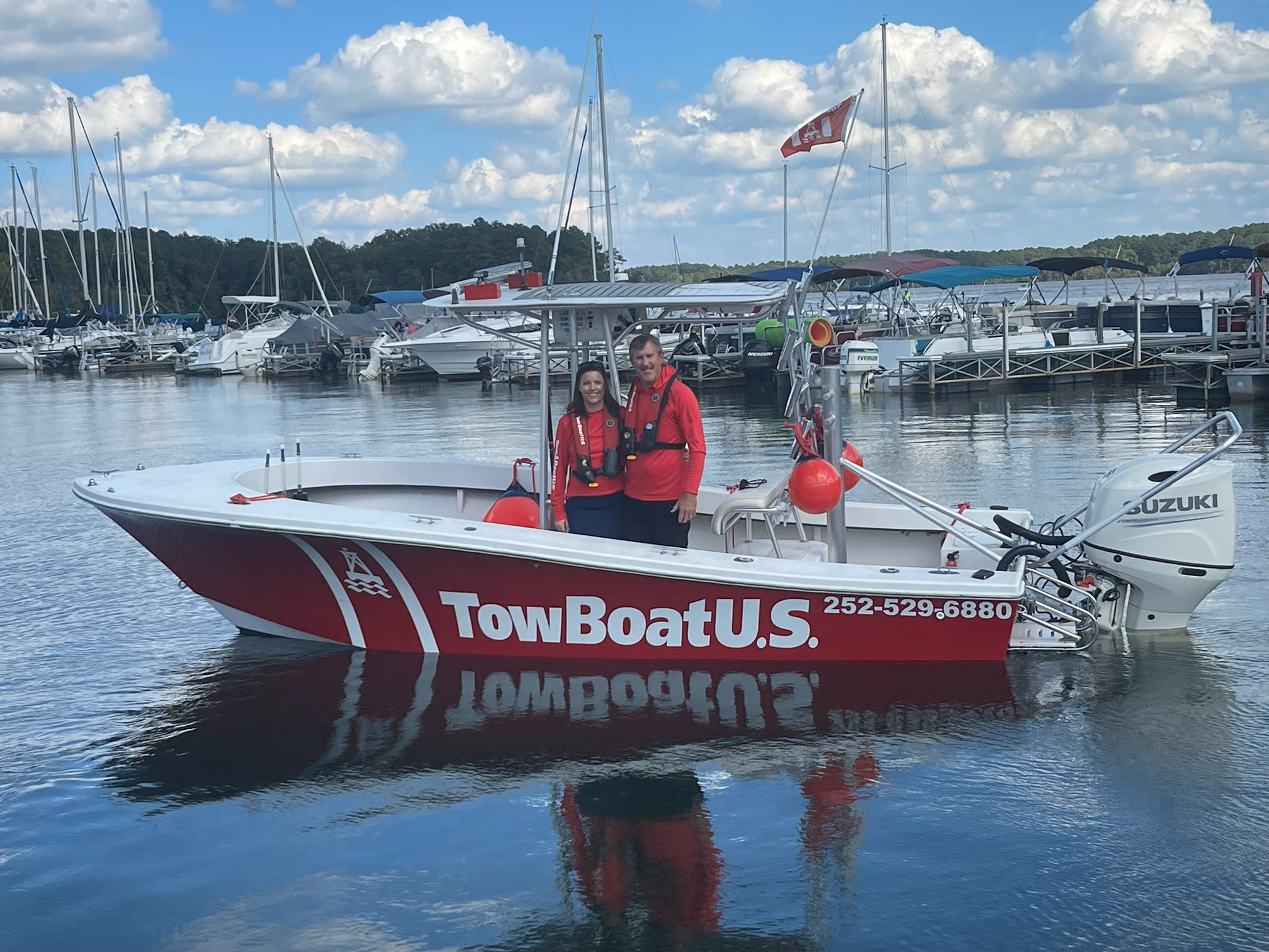 (L to R) Capts. Megan and Branson Mosier aboard their 21-foot Privateer TowBoatUS response vessel on Kerr Lake.